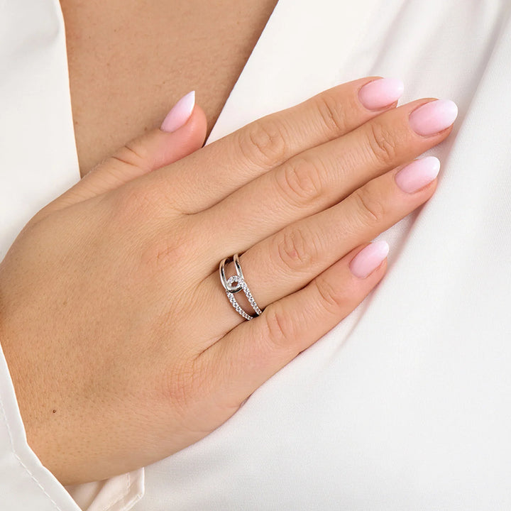 Silver ring with zirconia stone on woman's hand, front view, elegant design