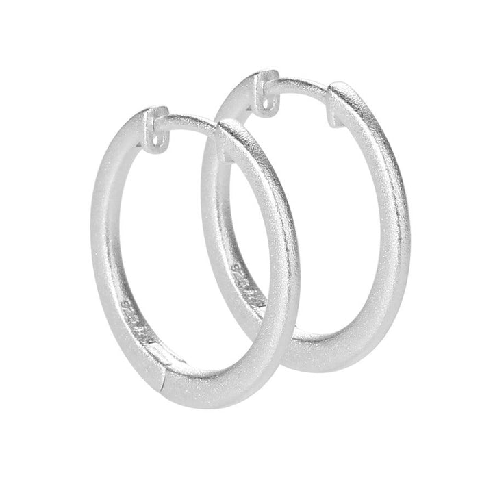 Aqua Dulce Juliet Sand Hoop shows two matte silver earrings in a simple, round design. Model 4660-4660-1
