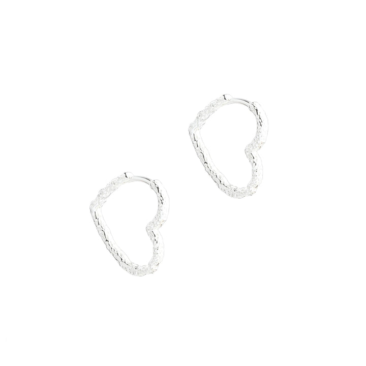 The Aqua Dulce Love Me Big Heart Hoop features two large, silver heart-shaped hoops in a hammered look. Model 5949-5949-1