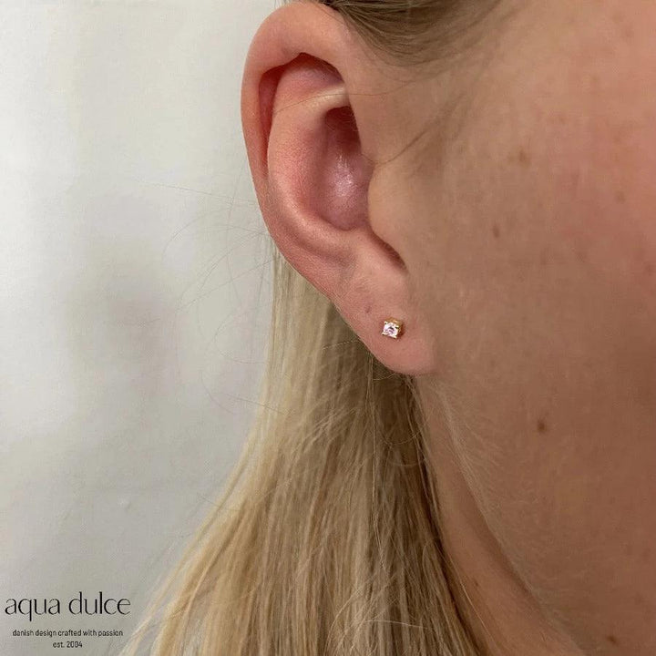 aqua dulce mini kaya pink earrings in silver-gilt can be seen on ear, simple and feminine detail. Model 5175-5175-2