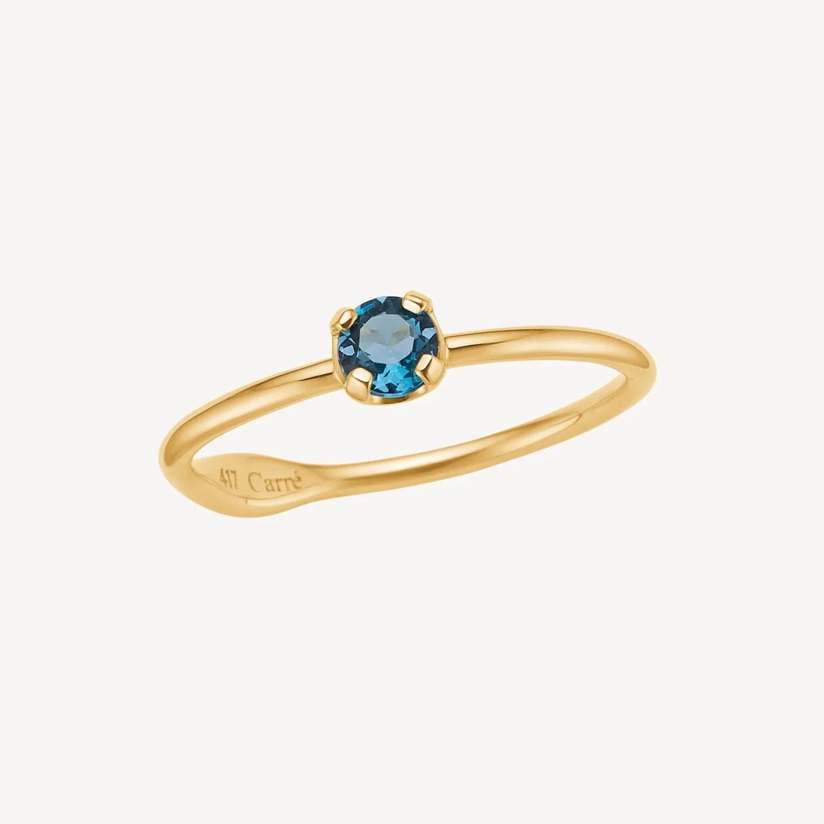 Carre Iris 10kt Gold Ring w. London Blue Topaz shows a simple gold ring with blue gemstones. Model TR4109LBT-001