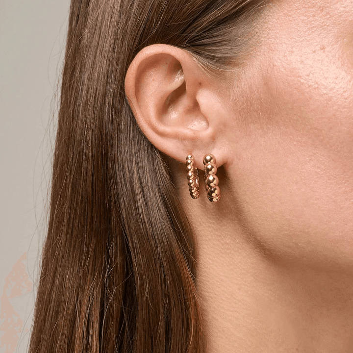 Enamel Ball Chunky Gold Plated Hoops 23mm shown on ear, round gold plated earrings with ball details. Model e401g-1.