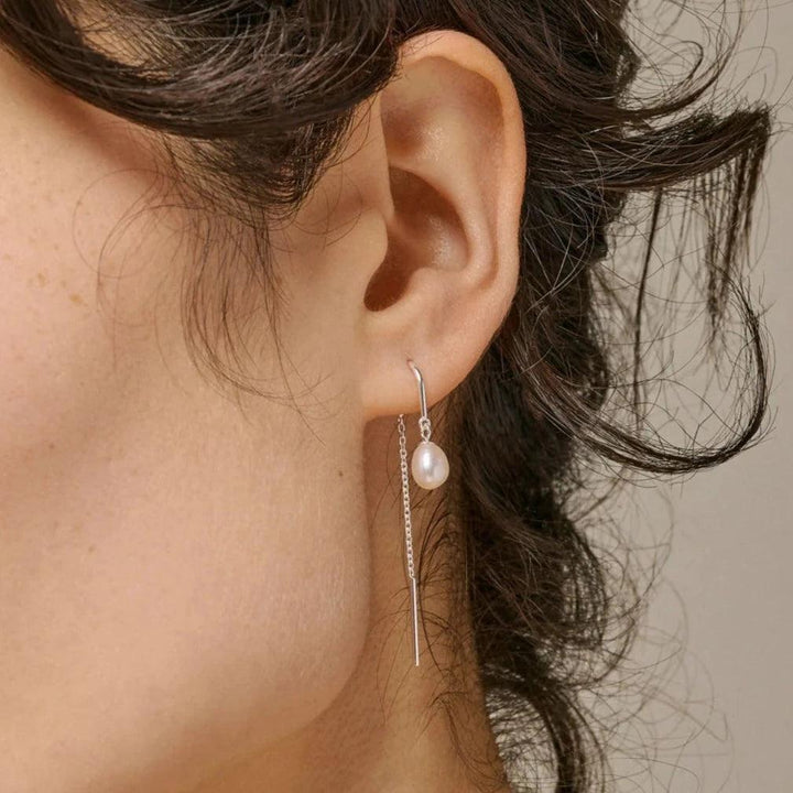 Enamel Eleanor Pearl Earrings appear on the ear with silver chain and elegant white pearl, model e308s-e308s-2.