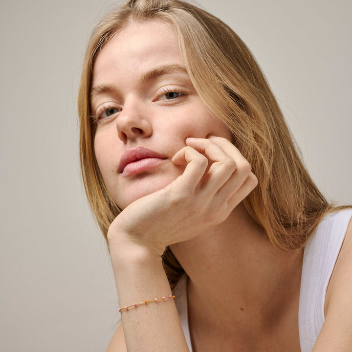 Enamel Lola Bracelet Blush in gold-plated silver appears on wrist, fine pastel colored beads, Model b66g-blush-2