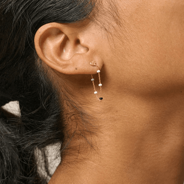 Enamel Lola Salt n Pepper Earrings show on ear, gold earring with fine chains and pearls, Model e140gm-salt pepper