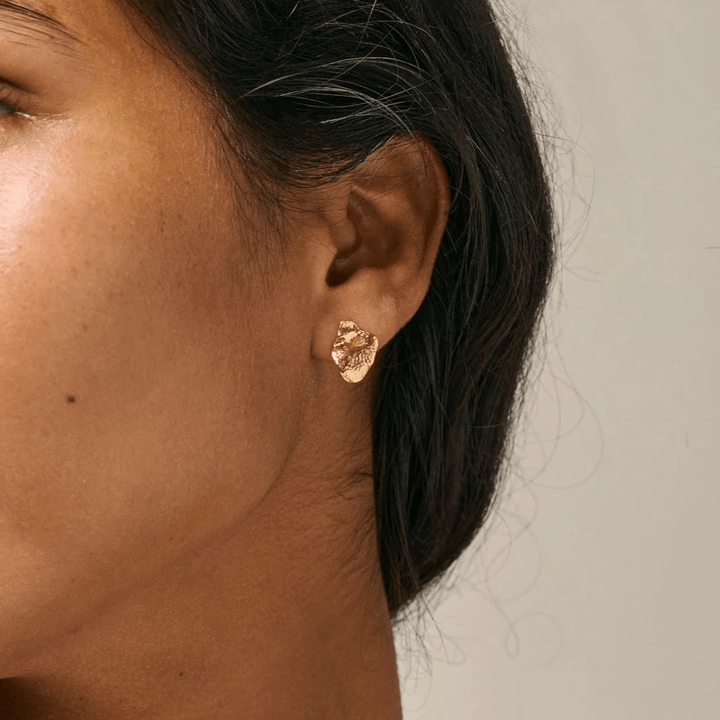 enamel maia small studs gold plated studs appear on ear, organic shape in glossy gold finish. Model e386gm