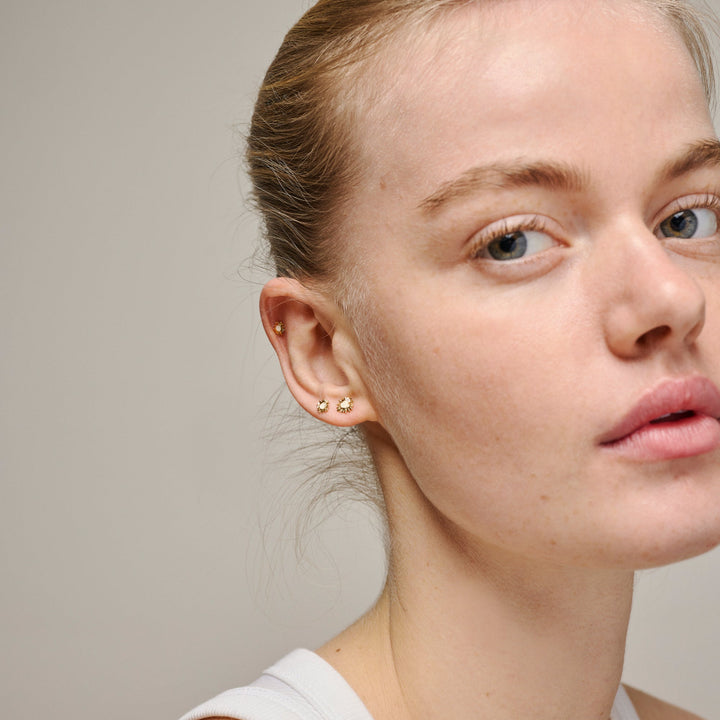 enamel mini sunshine stud daisy appears on the ear of a woman, nice small earrings in gold color look, Model e419g-daisy-2