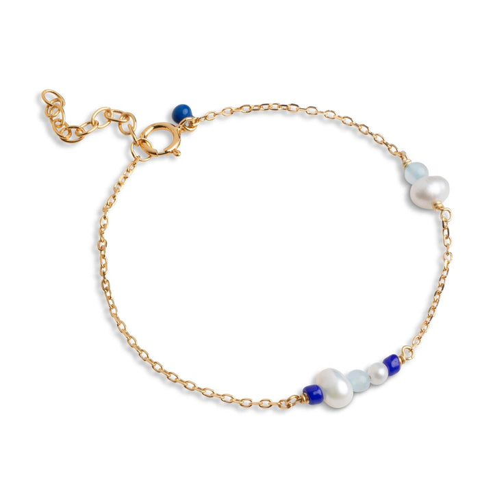 Enamel Sofia Bracelet Marine with golden chain, white pearls and blue details. Model b136g-marine.