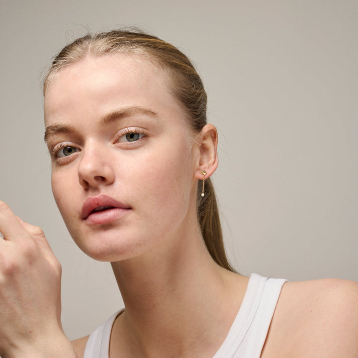 Enamel Sunshine Drop Earrings Daisy e423g-daisy shown on model, discreet gold earrings with small flower and drop. Model e423g-daisy-2.