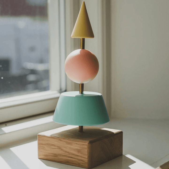 Fablewood Christmas tree Helga-1213 with geometric tree shapes in yellow, green and pink shades on an oak base. Model 1213-1