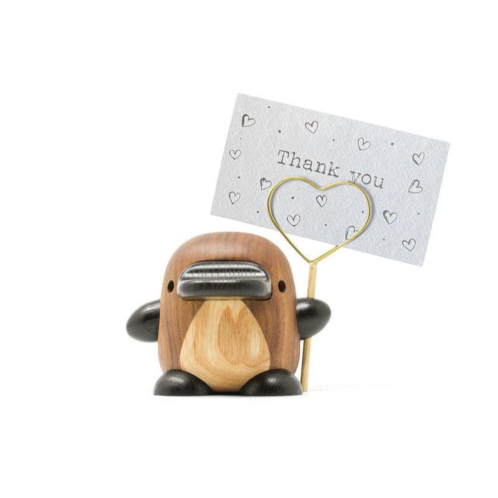 Fablewood Perry the Platypus shows a decorative wooden figure in shades of brown with a metal sign, Model 1403-2.