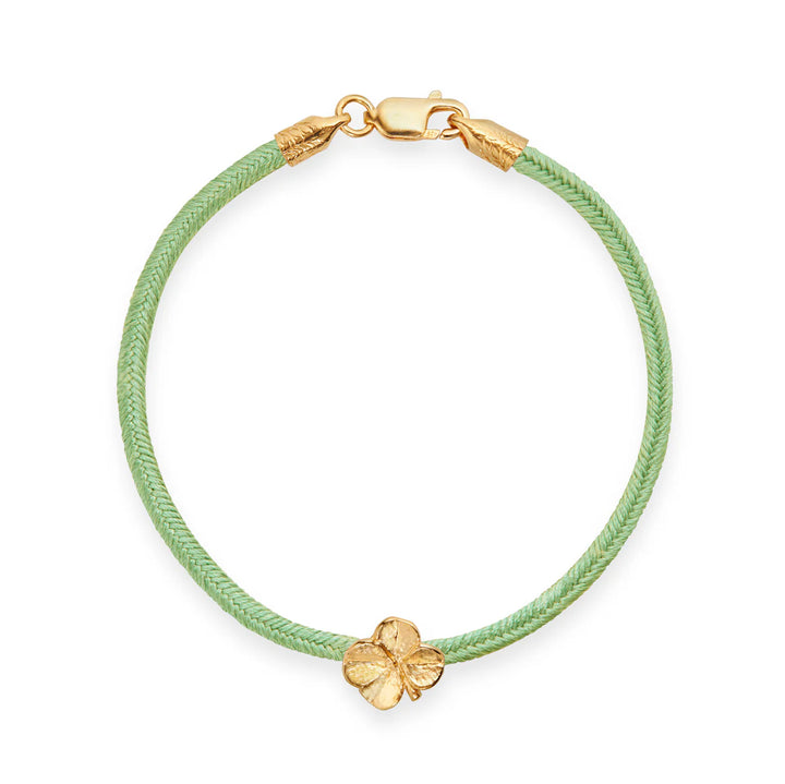 Flora Danica Clover Silk Bracelet Light Green Gilt shows an elegant light green silk bracelet with gilt clover detail and clasp. Model 907-flc-silk-lightgreen-g-001-1