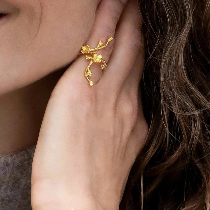 Flora Danica Forget-me-not Statement Ring displayed on hand, in glossy gold-tone finish and floral design. Model FMN-STRI-G-001-2