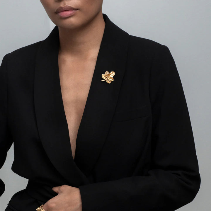 Flora Danica Rosenblad Brooch Gilded rose brooch shown on black blazer, elegant and detailed. Model bro-g-1