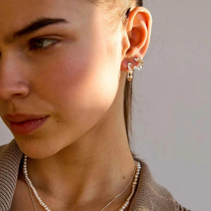 Hultquist Copenhagen Audrey Petite silver earrings worn by woman, elegant detail. Model S08603S-2