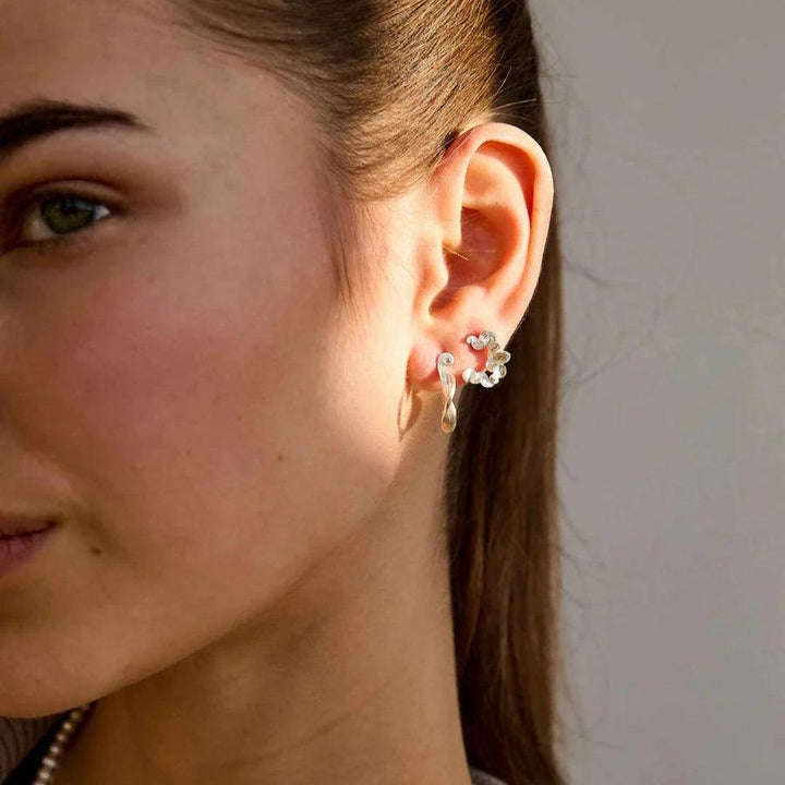 Hultquist Copenhagen Audrey Silver Hoops S08601S appears on women's ears in daylight. Model S08601S.
