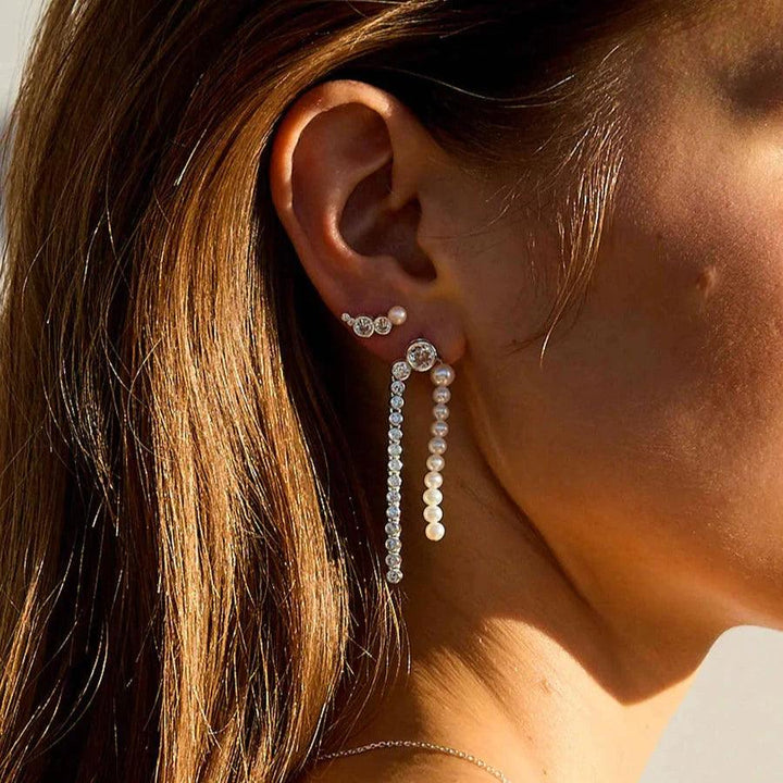 Hultquist Copenhagen Harper Croissant silver earring shown on ear with glossy finish in sunlight. Model S08607S-2