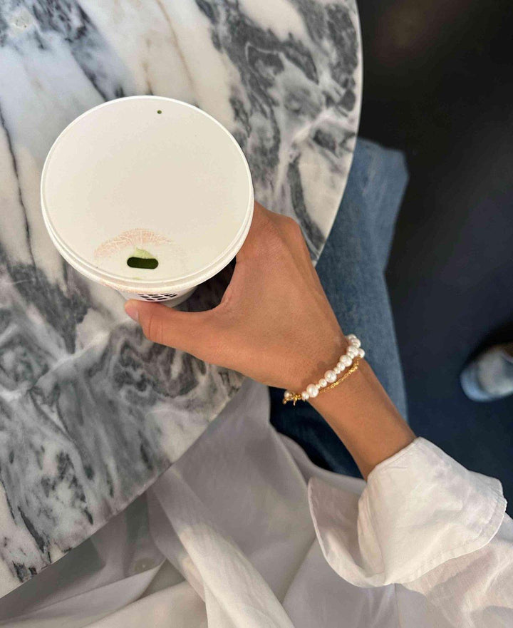 Hultquist Copenhagen Josephine bracelet with white pearls and gold details worn on hand, Model S08559G-2.