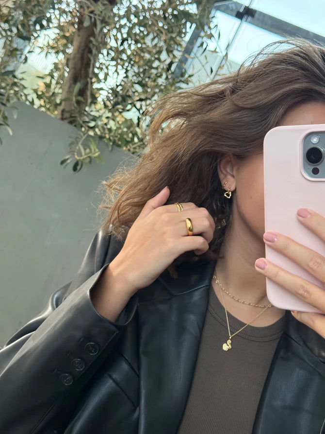 jeberg-jewellery-pirouette-double-hoops in gold-plated silver worn by woman with dark hair, Model52840-2