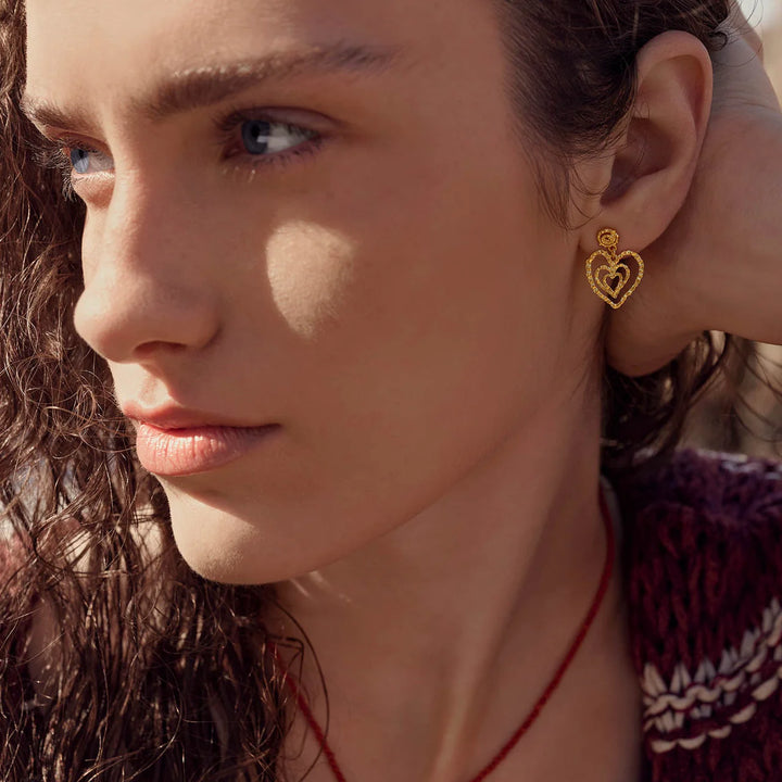 Maanesten Beate Petite gold-plated heart earrings worn by woman, showing gold-tone detail, Model 10088A