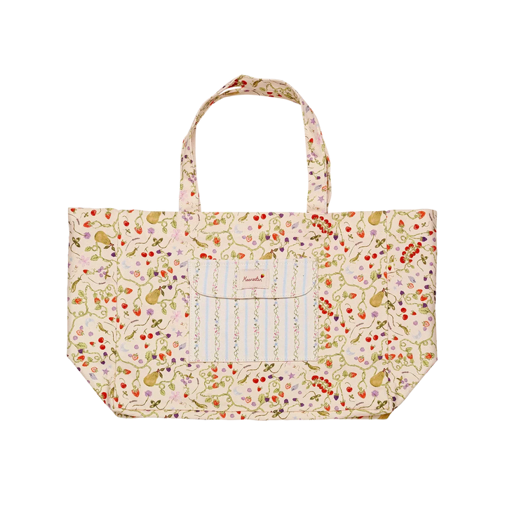 maanesten-big-canvas-tote-garden-magic-ivory shows large beige canvas tote bag with colorful floral pattern and front pocket. Model 4122-1