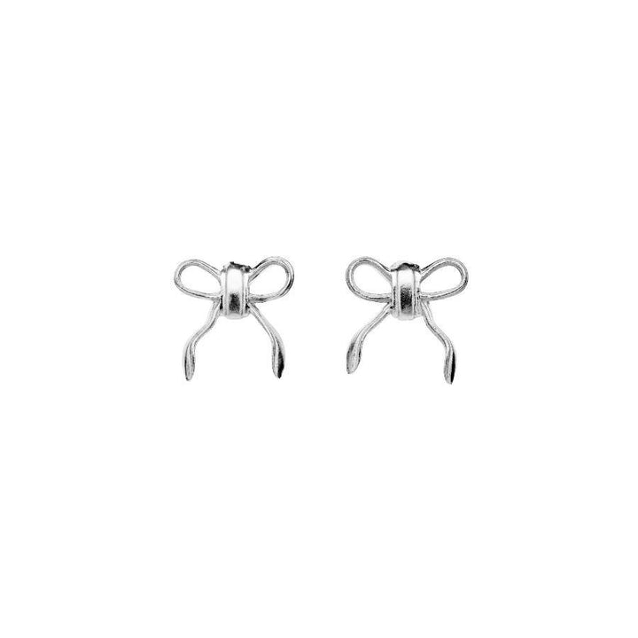 Maanesten Eunice Silver Bow Stud Earrings showcases a pair of elegant earrings in silver with a bow design. Model 9944c-1