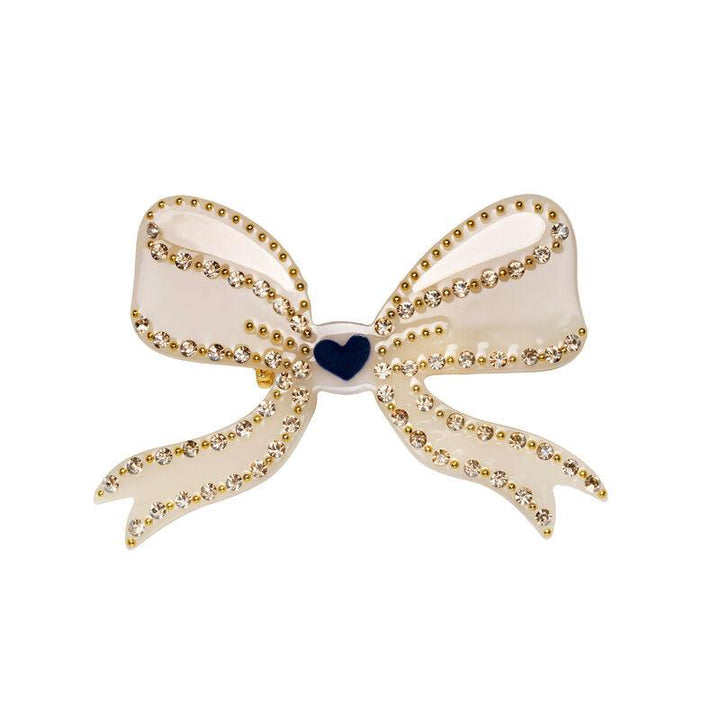 maanesten memoru brooch cream shows a cream colored bow brooch decorated with golden details, Model3991-onesize