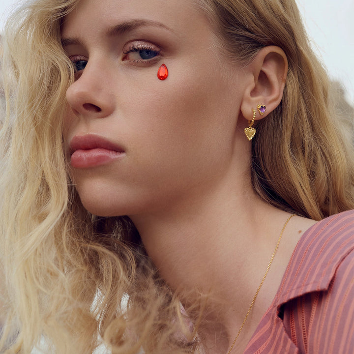 The moonstone Rosalinde gilded heart creole is shown worn by a woman, elegant and detailed. Model 10054a