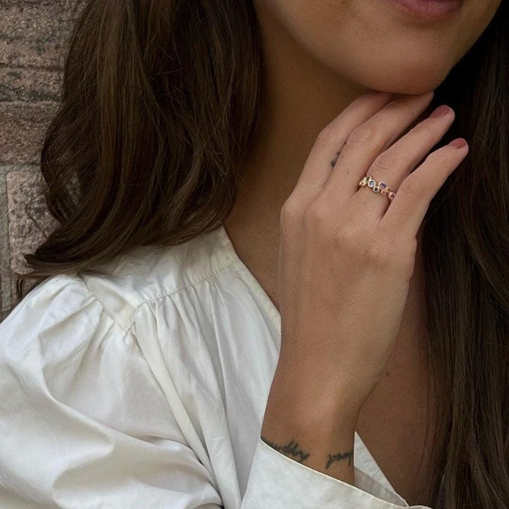 Mads Z 14 kt luxury rainbow ring with real stones displayed on woman's hand, elegant colored stones. Model 1544062-001