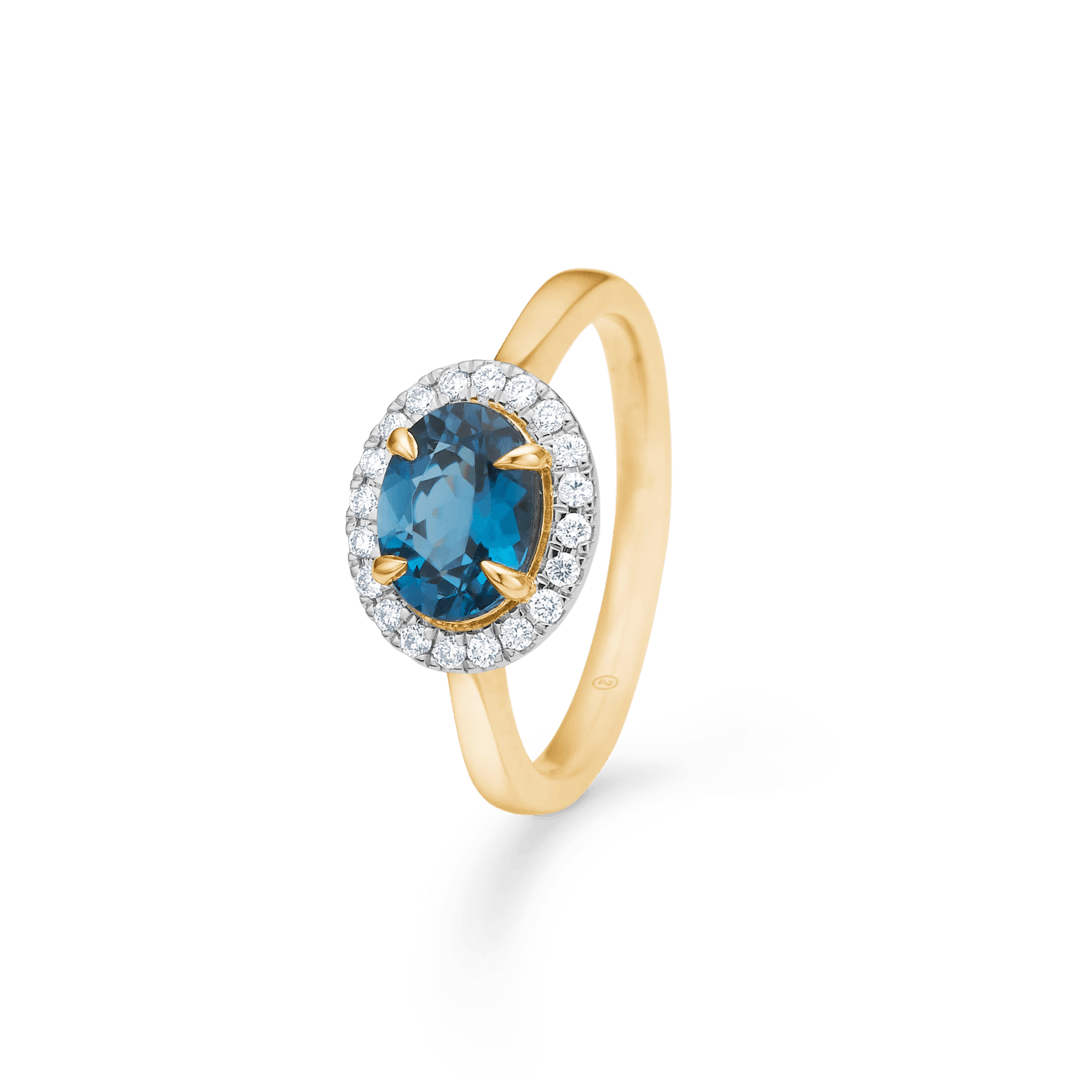 Engagement ring in 14 kt gold with blue topaz and diamonds