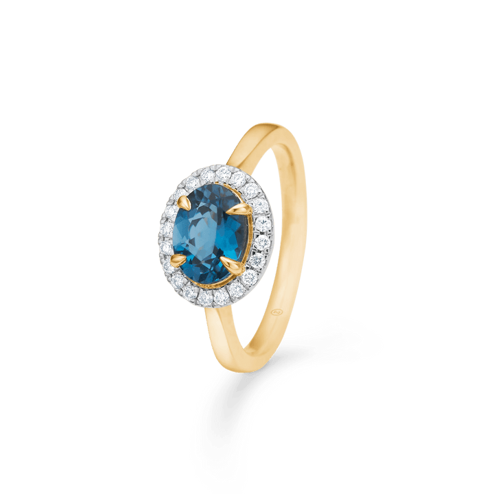 Engagement ring in 14 kt gold with blue topaz and diamonds