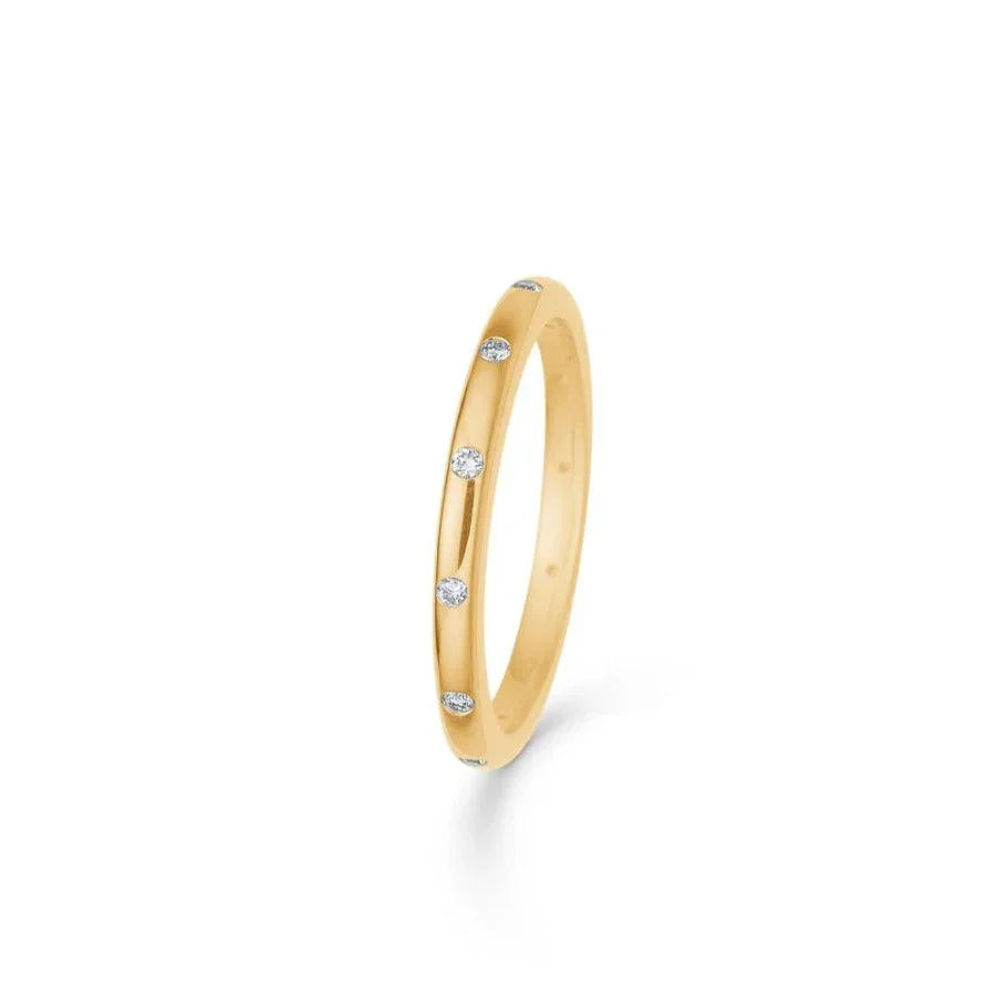 Mads Z 14kt Poetry Ring 0.11ct W/SI shows a simple gold ring with small diamonds evenly spaced. Model 1541042-001