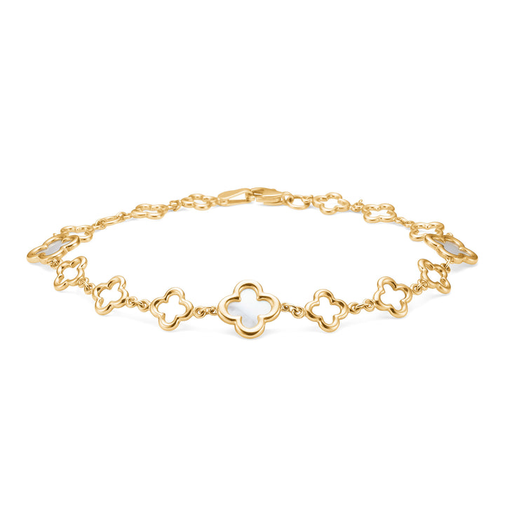 Mads Z Aurelia bracelet in 8kt gold with white flower details, lying on a white background. Model 3356043-1
