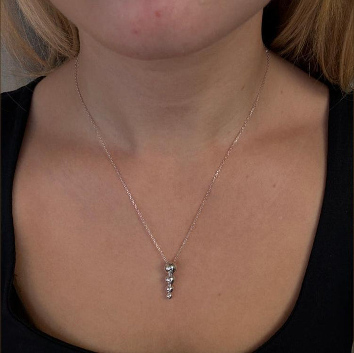 Mads Z Biggest Ball silver necklace with pendant, worn by a woman, shiny balls. Model 2120177-2