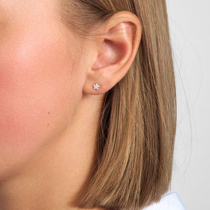 Mads Z Celeste Diamond Earrings in 14kt gold appear on the ear, elegant flower with sparkling diamonds. Model 1511132-2