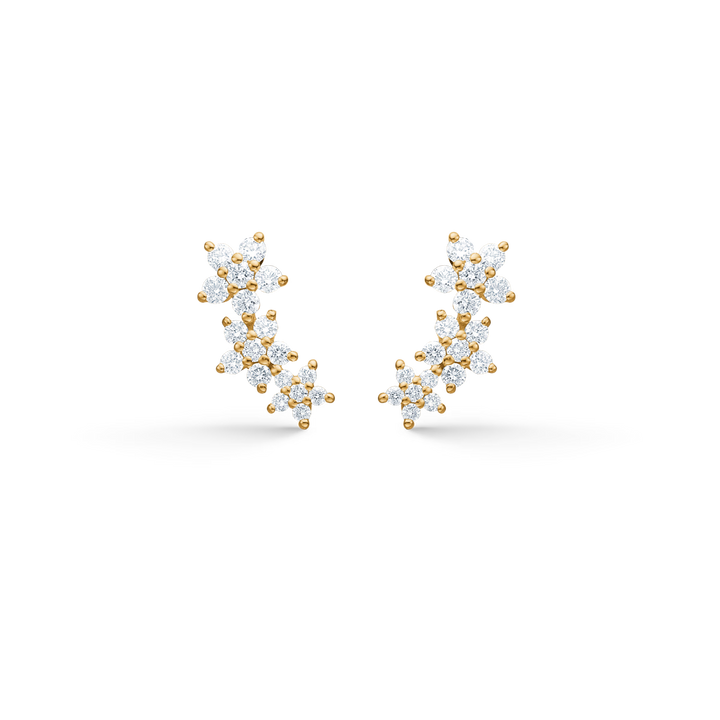 Mads Z Celeste Diamond Stud Earrings in 14kt gold features curved studs with flower-shaped diamonds. Model 1511142-1.