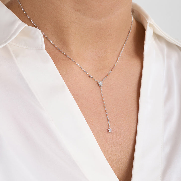 Mads Z Celeste silver necklace with rosé zirconia is shown worn on the neck, elegant Y-shaped design. Model 2127143-1