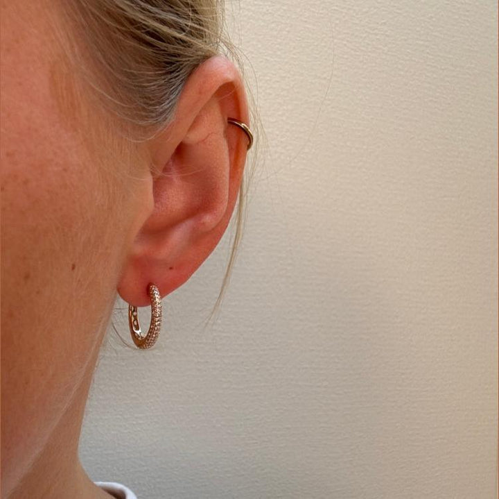 Mads Z La Boheme 8kt Gold Creoles Zirconia shown in the ear, elegant gold color and sparkling stones. Model 3317031-2