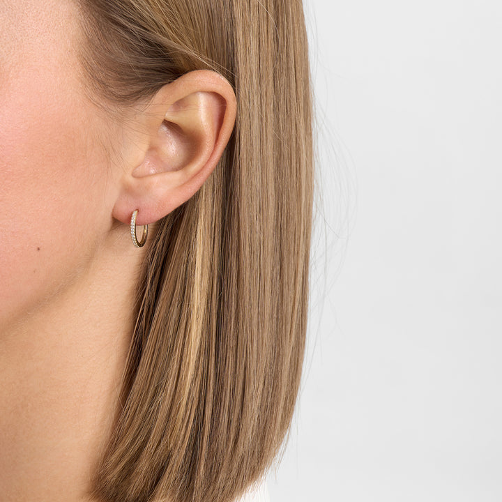 Mads Z Lumina 14kt gold creoles with diamonds 14mm worn discreetly in the ear, Model 1511085-2.