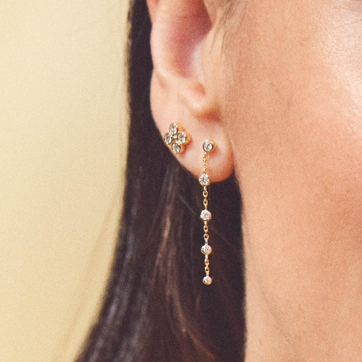 Mads Z Sophia's Bloom 14kt gold stud earrings with 0.16ct W/SI shown worn, flower and chain with diamonds. Model 1511194-2