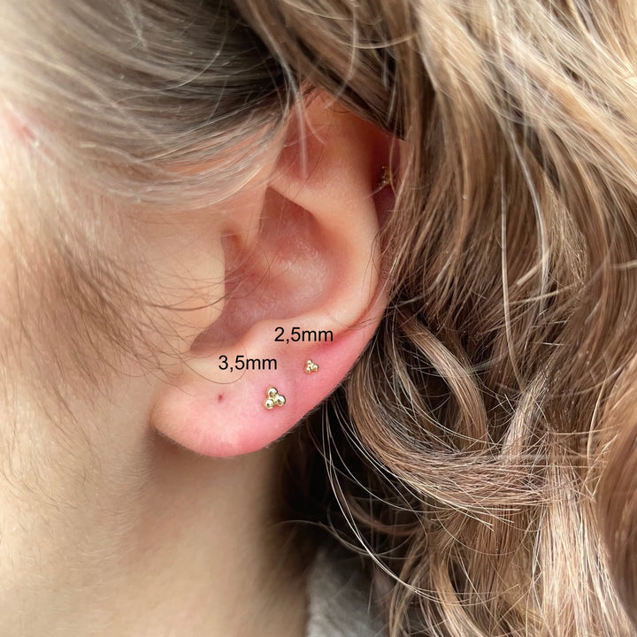 Maria Tash Ball Trinity Threaded Stud 2.5mm in gold, elegant detail in the ear on person, Model xbtr-yg-w25-001-2