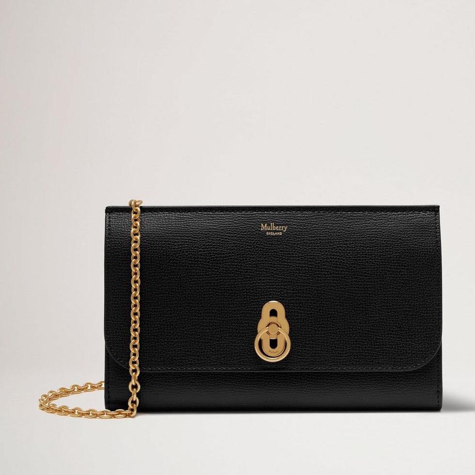 Mulberry The Amberley Clutch Small Classic Grain Black is seen as an elegant black leather clutch with gold chain and signature clasp. Model RL6090205A100.