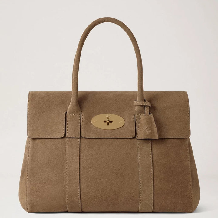 Mulberry Bayswater Salcombe Sand Suede shows a sand colored suede handbag with gold buckle. Model HH9882047P705