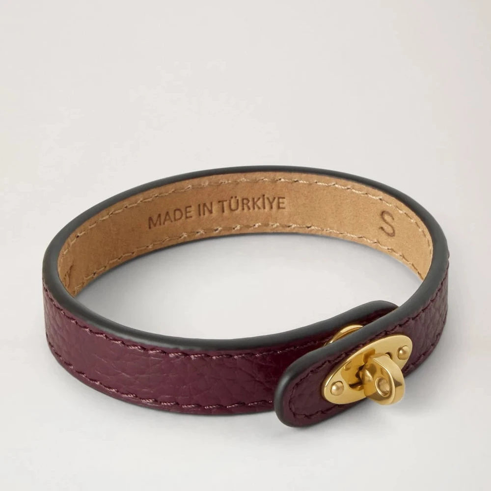 Mulberry Bayswater Thin Bracelet Black Cherry in dark red leather with gold buckle, seen from the side. Model QB2390205K560