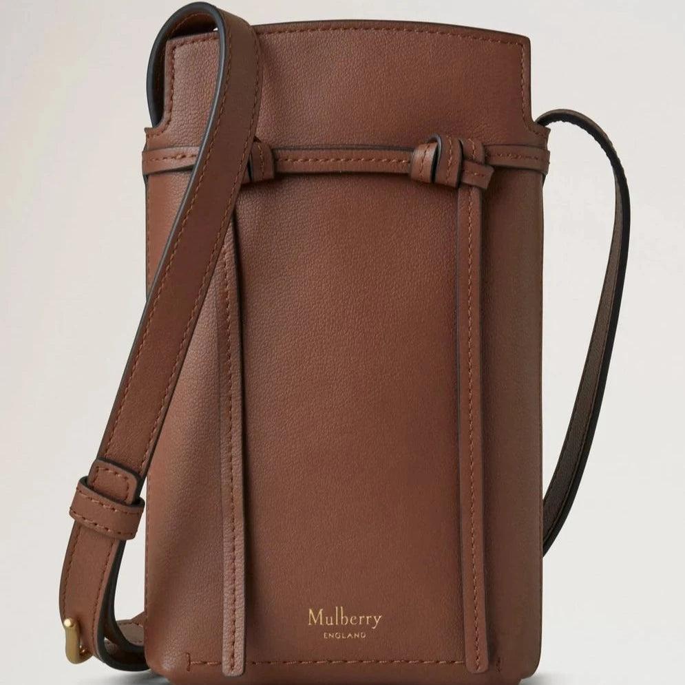 Mulberry Clovelly Phone Pouch Micro Classic Grain Oak features a compact brown leather phone pouch with adjustable strap. Model RL8557587G222.