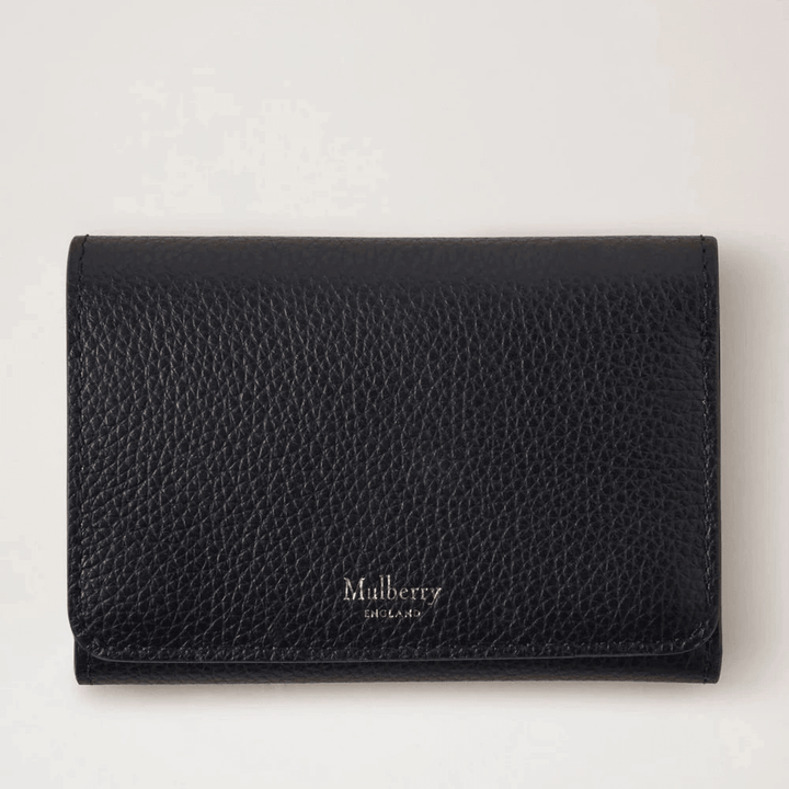 Mulberry Continental Trifold Card Holder black in black embossed leather, seen from the front in a studio environment. Model rl6824205a100