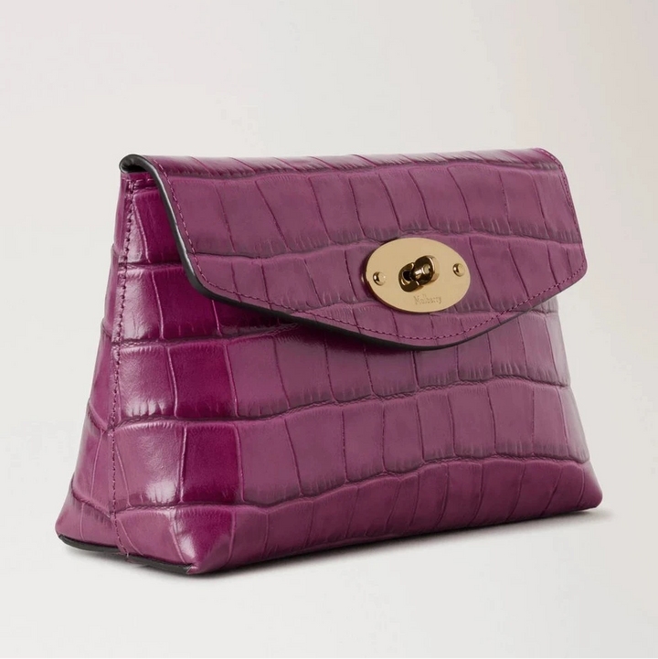 Mulberry Darley Cosmetic Pouch Orchid Bloom Shiny Small Croc shows a small cosmetic pouch in shiny purple crocodile embossed leather with a golden clasp. Model RL8187641J512.