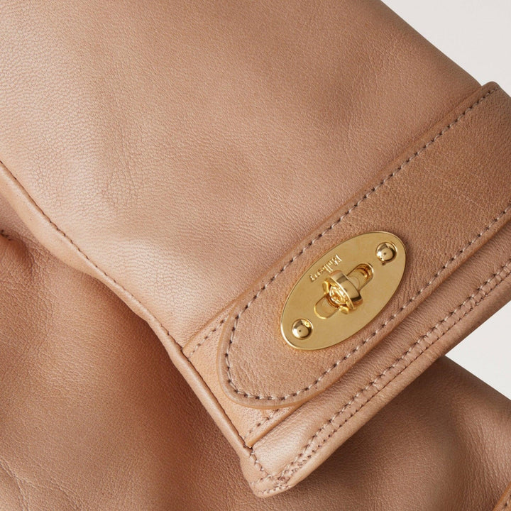 Mulberry Darley Gloves shows close-up of soft, light brown leather glove with elegant golden buckle. Model VG4105243E631-001