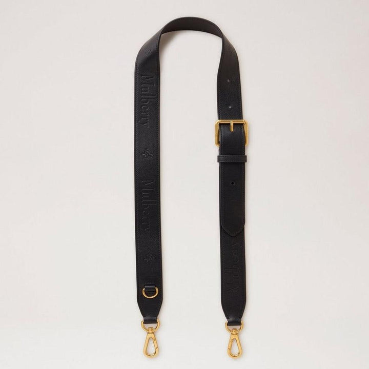 Mulberry debossed logo leather strap in black leather with adjustable buckle and golden metal parts. Model RX0284587A100.