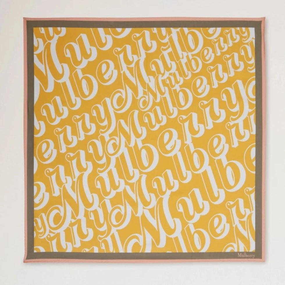 Mulberry Fantasy Logo Square Scarf shows a yellow scarf with white Mulberry- print and pink border. Model VS4802027P504